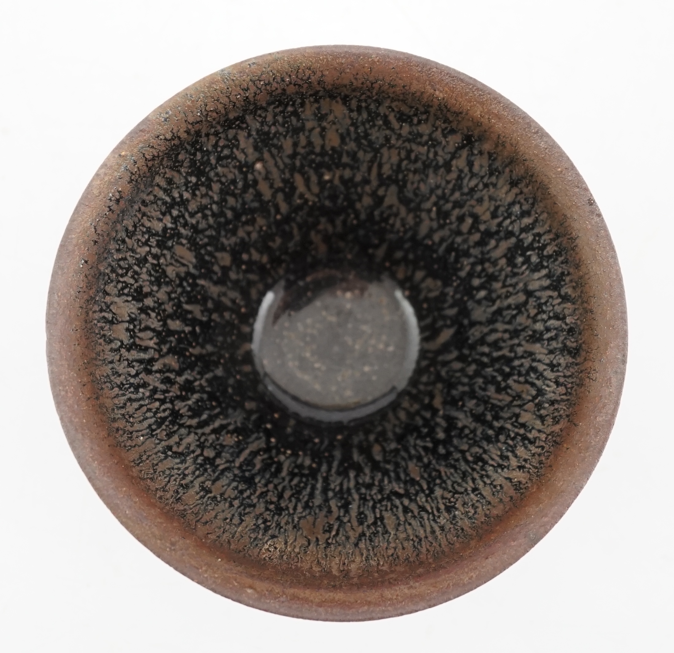 A Chinese 'hares fur' pottery bowl, Song Dynasty with a thick glaze pooling above the unglazed base, 12.2cm diameter. Provenance - Robert Ricketts collection. Condition - good